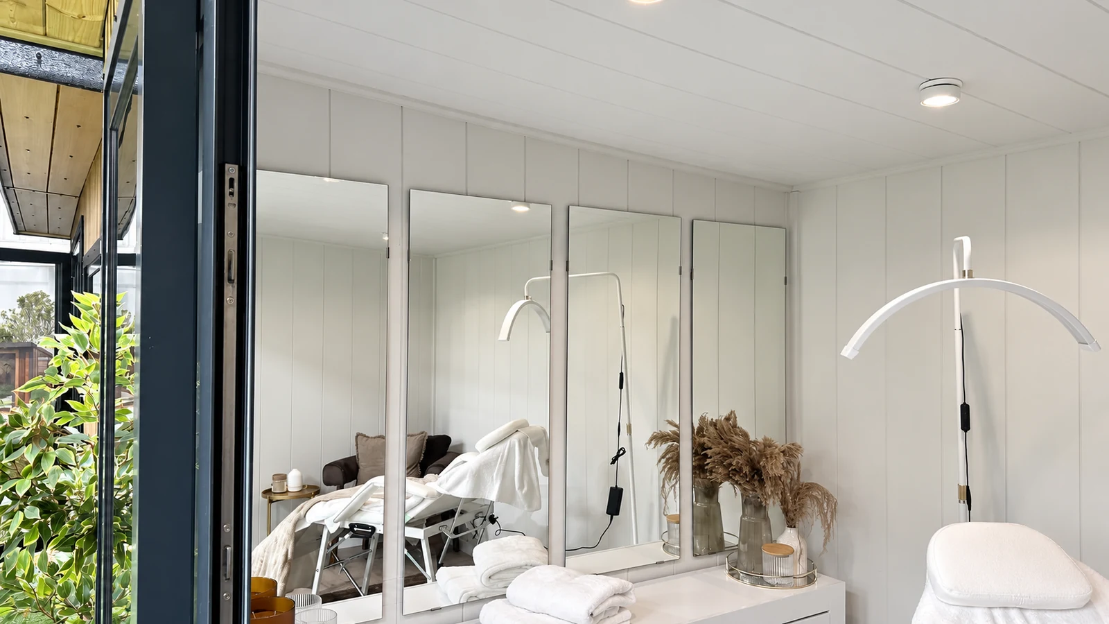 Beauty treatment room display with a treatment chair and mirrored wall in the Noah showroom