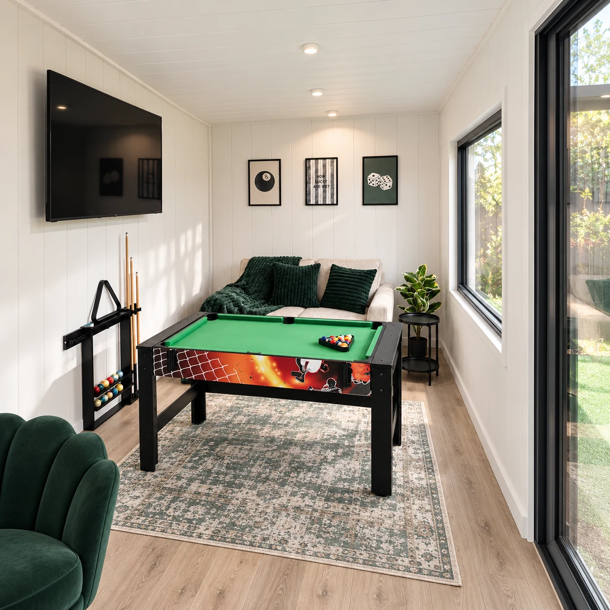 Games room display with a pool table and wall-mounted television in the Noah showroom